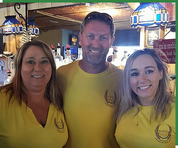 Three people in yellow shirts posing for a picture.